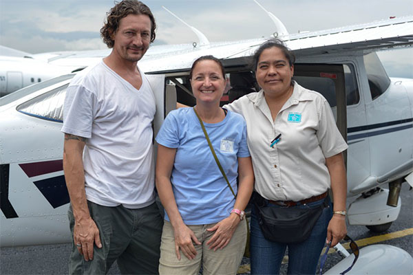 Scientists pre-flight outside a small plane