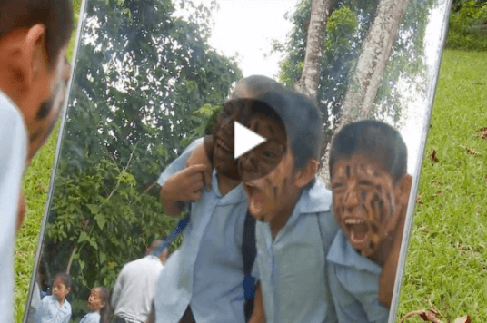 Thumbnail of three boys with jaguar face paint looking in mirror and roaring