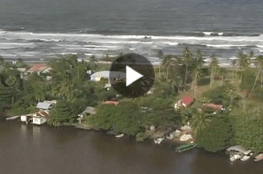 Thumbnail aerial of homes by oceanside with intercostal water in foreground