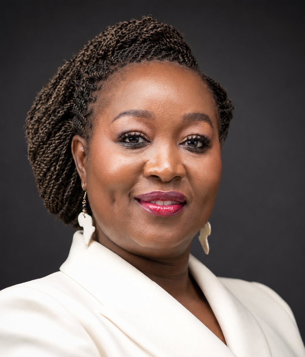 Lorna Wambayi wears a cream-colored blazer and statement earrings, her braided hair styled against a dark background.