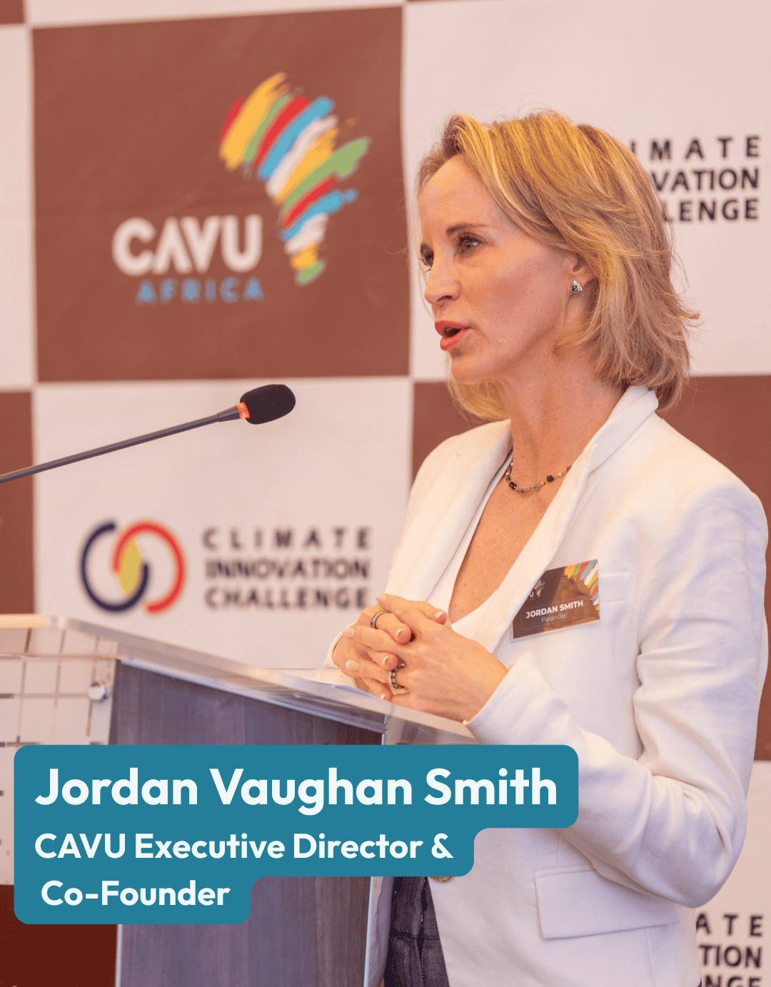A woman stands at a podium speaking, wearing a white blazer and name tag. Behind her is a backdrop with CAVU Africa and Climate Innovation Challenge logos, featured in the July 2026 edition of the Hope in Action Newsletter.